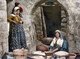 Palestine: Palestinian women kneading dough to make bread, c. 1900